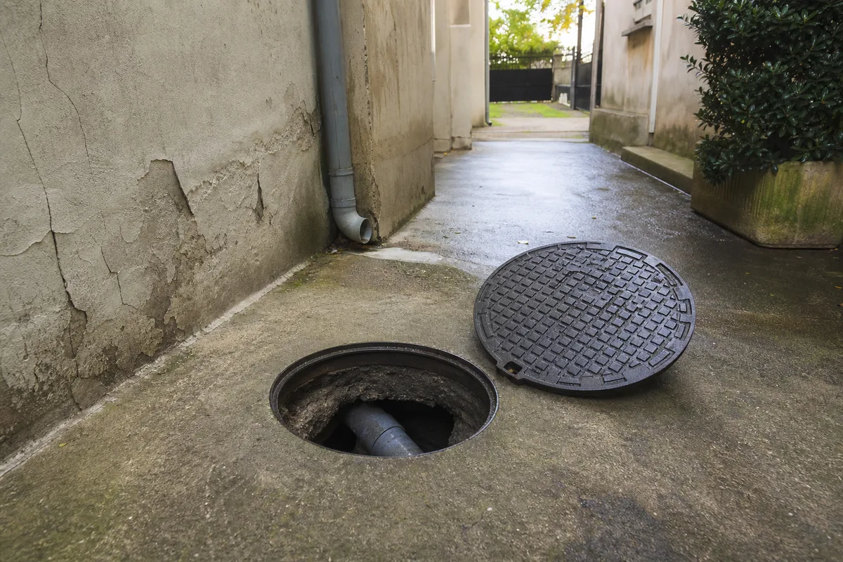 Regard de visite ouvert dans la cour d’un immeuble du Val-de-Marne